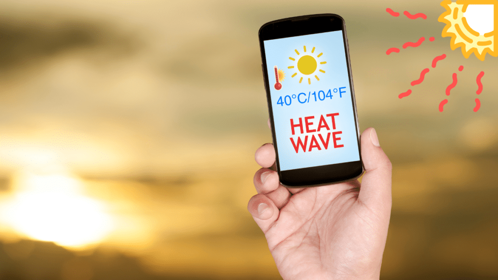 Person holding a mobile phone displaying high temperature and heatwave alert